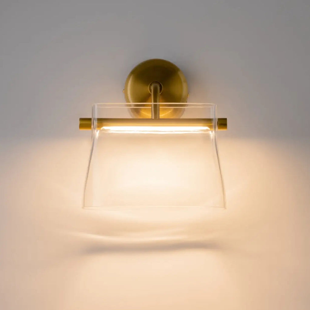 Applique murale LED finition laiton, abat-jour en verre transparent