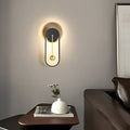 Applique murale à halo lumineux et sphère suspendue