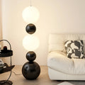 Lampadaire noir minimaliste à boules lumineuses