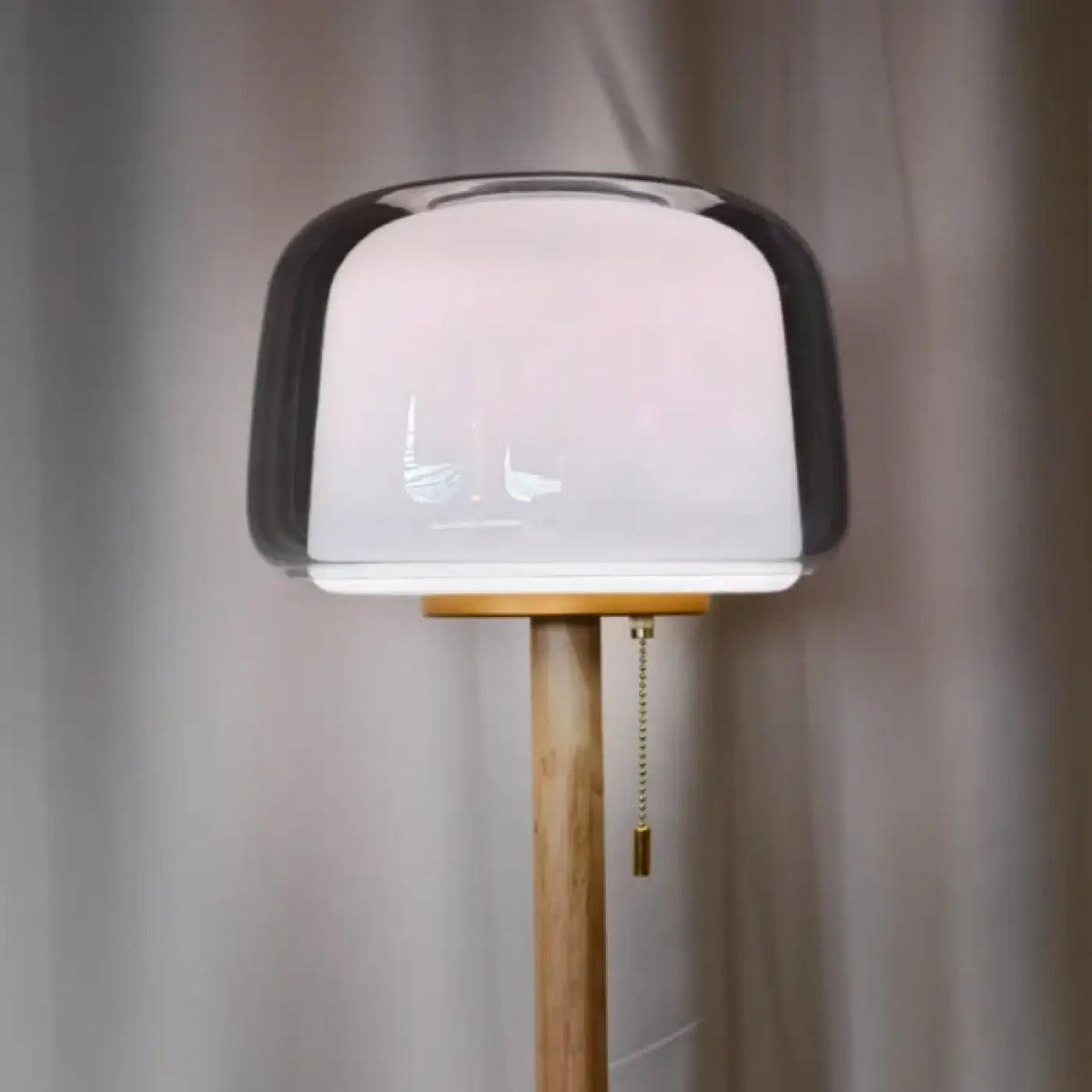 Lampadaire en verre transparent sur tige en bois