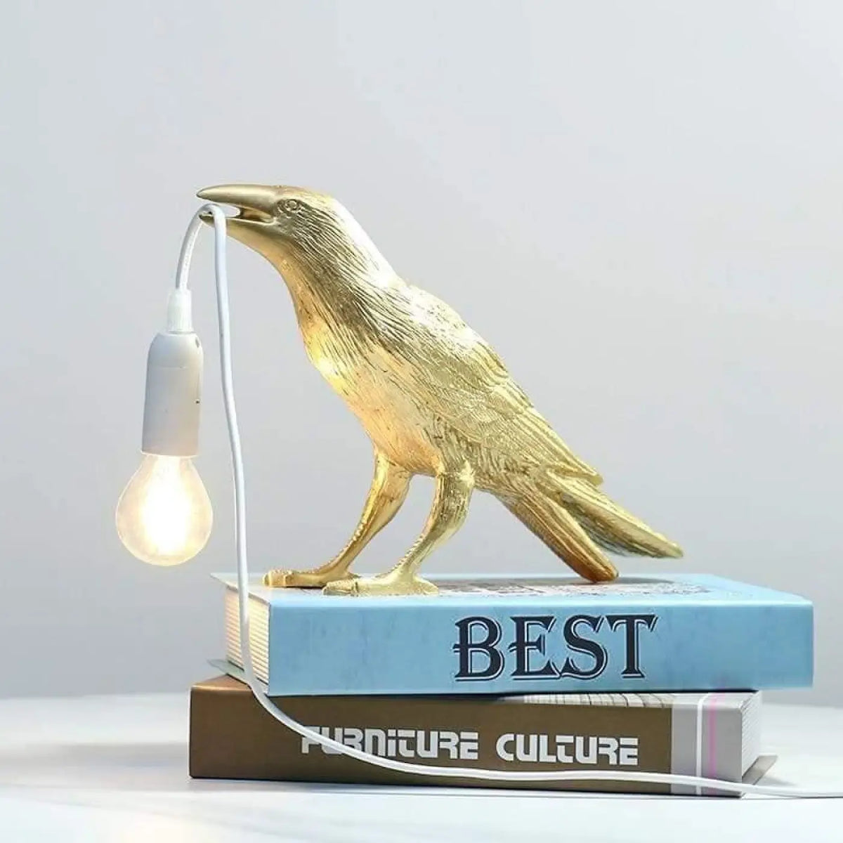 Lampe corbeau à poser, l'oiseau tient l'ampoule, trois coloris, doré
