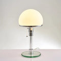 Lampe de table en verre transparent sur pied chromé