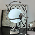 Lampe à poser effet planète sur base métallique