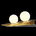 Lampe à poser dorée, deux globes de verre blanc
