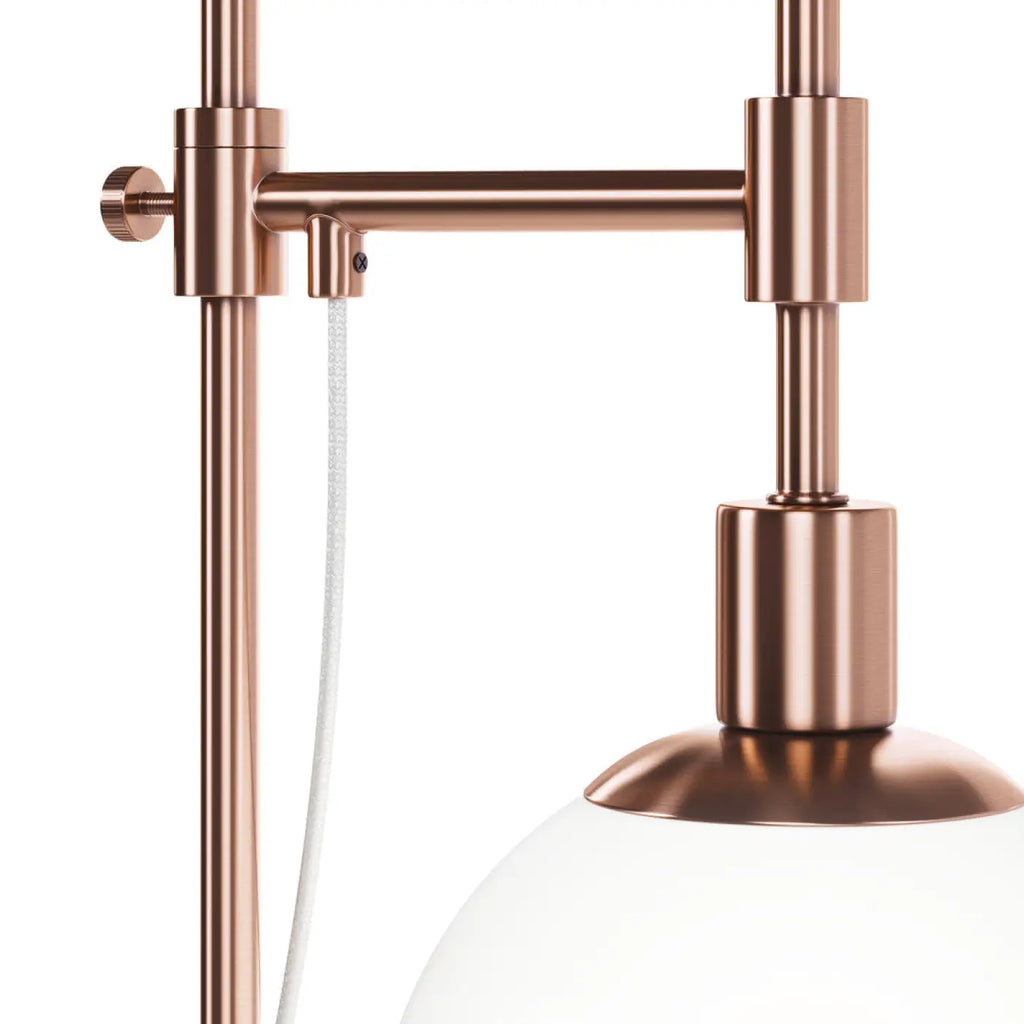 Lampe à poser globe en verre opalin orientable, finition cuivre