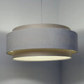 Suspension en tissu crème, lumière douce et ligne moderne