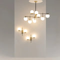 Suspension six globes opalins, acier noir et doré, 100 cm